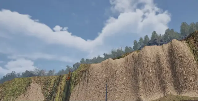 Rock cliffs topped with trees under a blue sky in the game