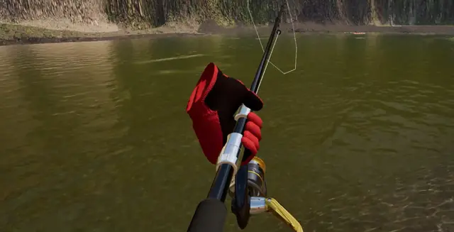 A gloved hand turning the reel, seen from above