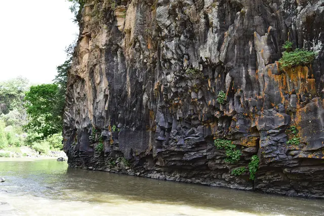 Columnar basalt cliffs above the water on a branch of the Hantan River