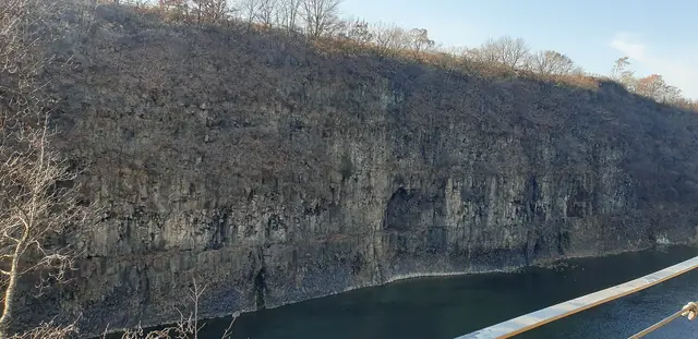 The basalt cliffs of the Hantan River gorge in autumn