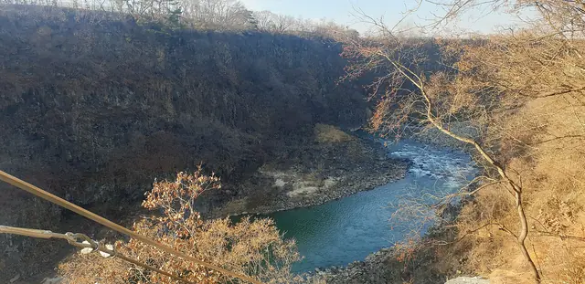 The basalt cliffs of the Hantan River gorge in autumn